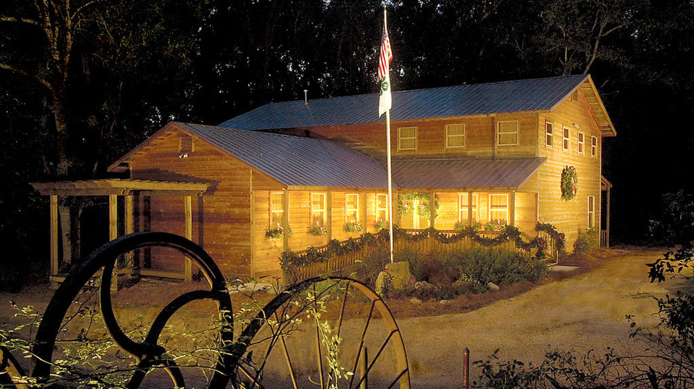 The Mississippi 4-H Museum at night illuminated with lights.