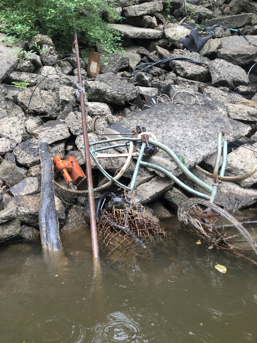 Cleanup equipment resting in shallow water at the edge of a rocky bank. Photo credit: Submitted