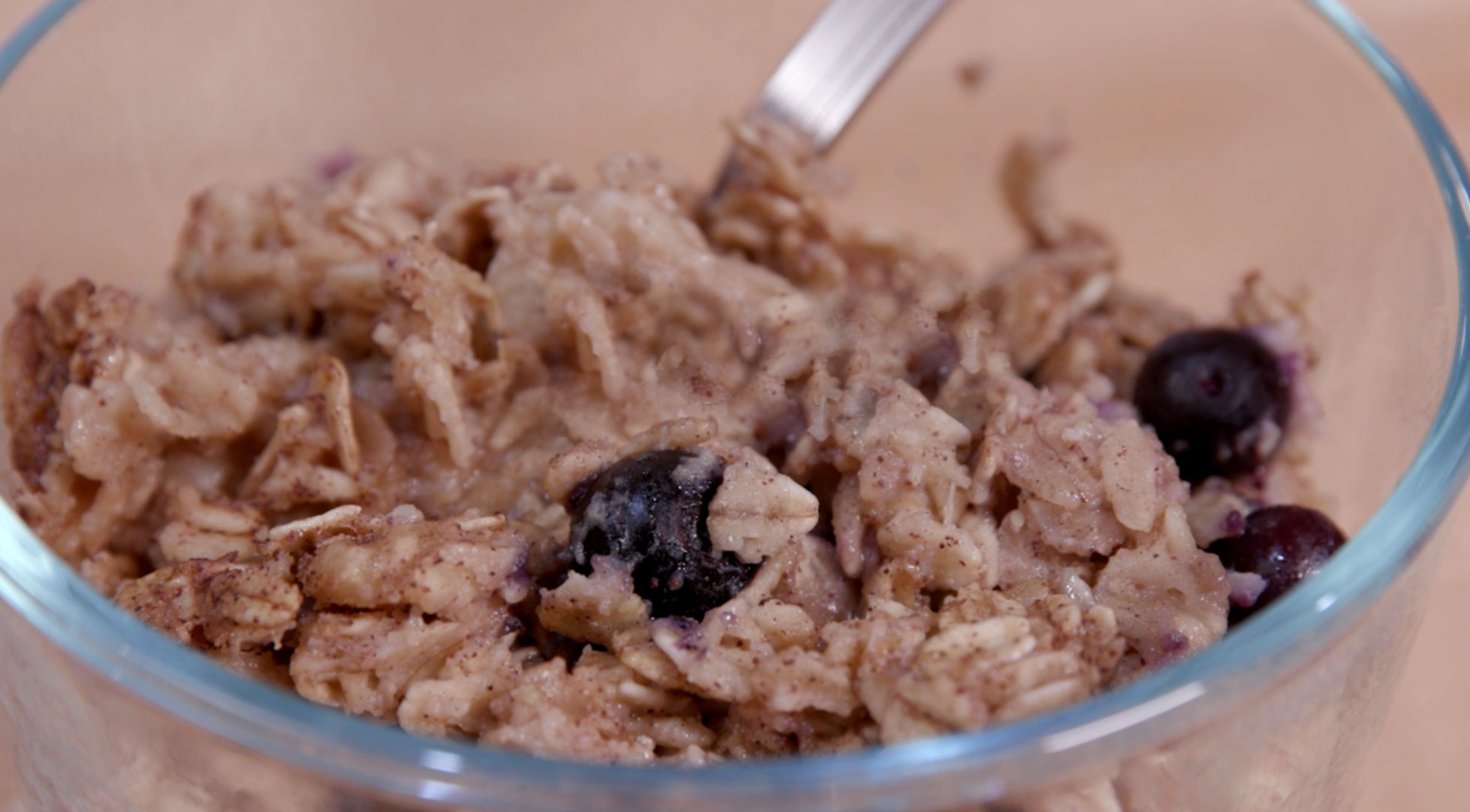 Baked blueberry oatmeal in a clear glass bowl