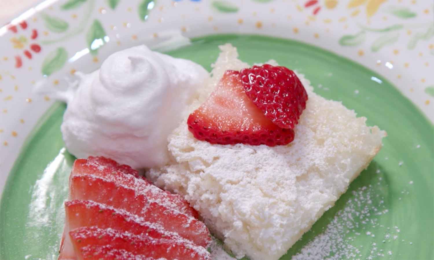 Pineapple angel food cake with sliced strawberries and whipped cream