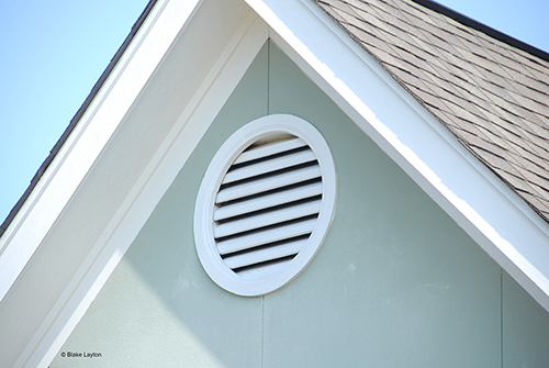 an insect screen behind a gable vent.