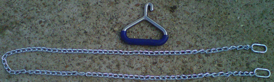 A long, metal chain with two large pieces on each end, and a metal handle with a hook.