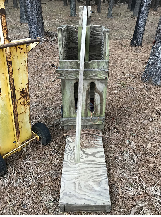 A manmade hand baler made of wood.