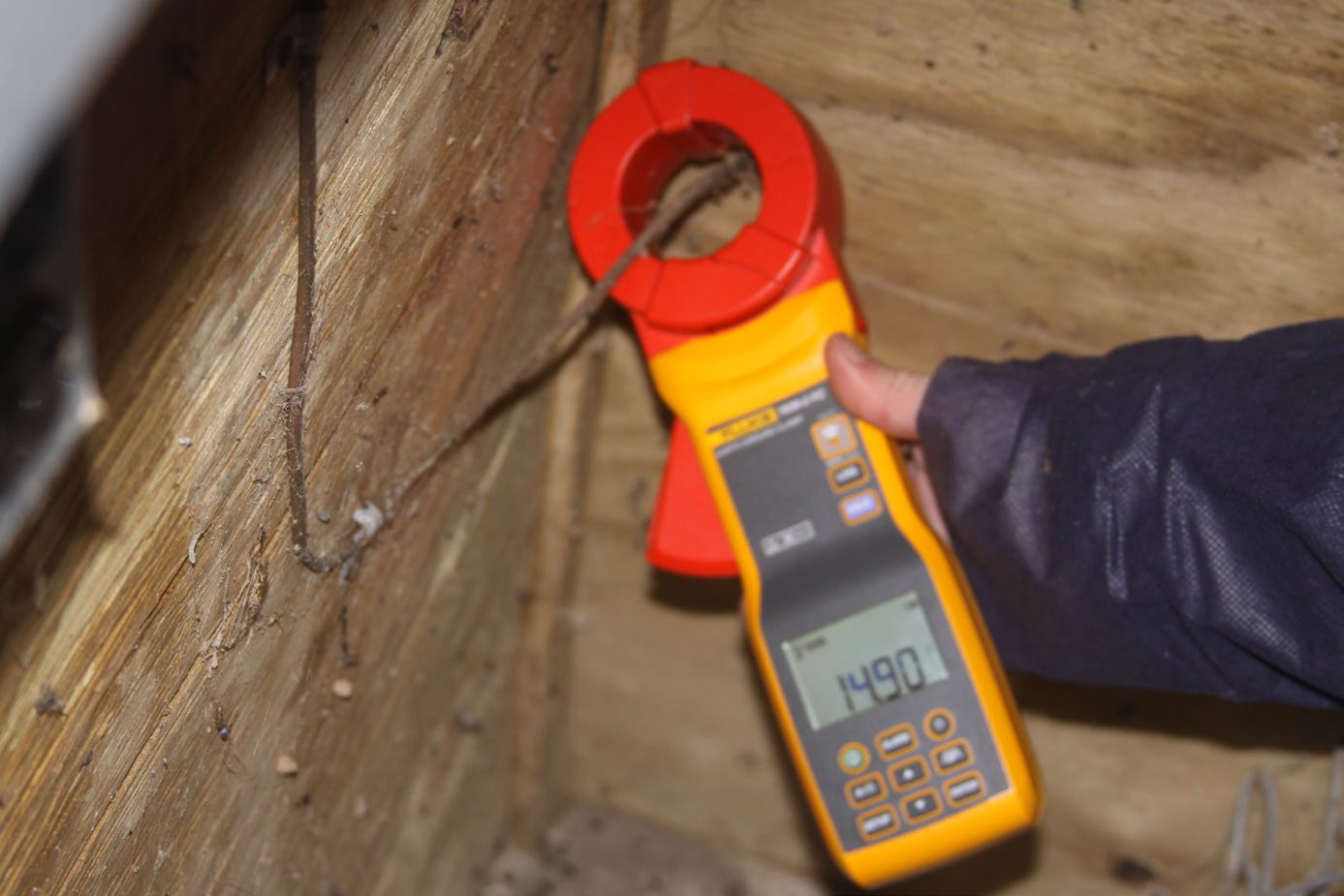 A properly grounded control room breaker box is reading 14.90 Ω on the ground resistance meter.
