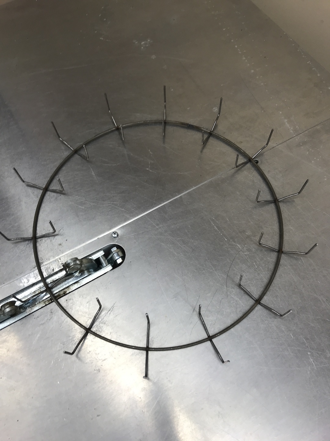 Metal circle with with wire prongs all around.