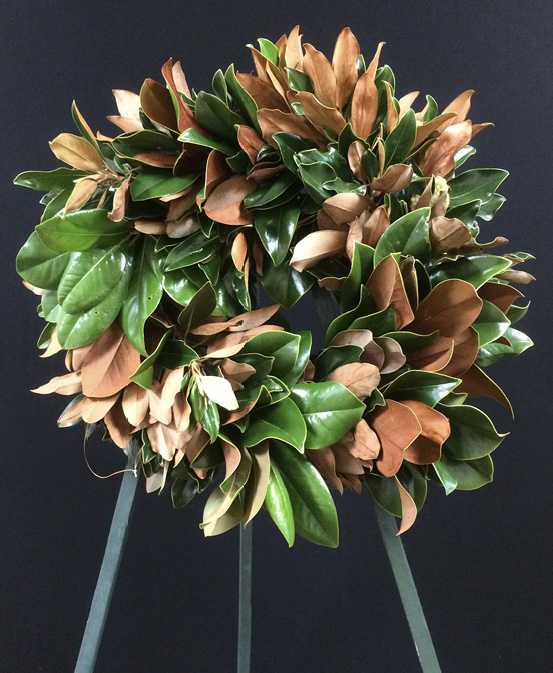 Magnolia leaf wreath made of green and brown leaves.