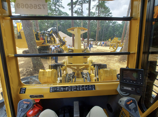 Photo taken inside the cab of a logging machine. 