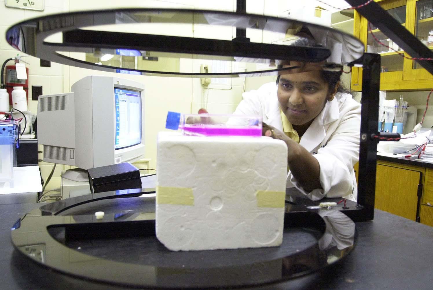 Wasana Siyambalapityage, a master's student at Mississippi State University, positions a tissue culture flask containing breast cancer cells under the resonance generator in the College of Veterinary Medicine. A native of Sri Lanka, she assists researchers in CVM's Department of Basic Sciences in a search to find electromagnetic fields that can reduce the side effects of traditional cancer treatments.