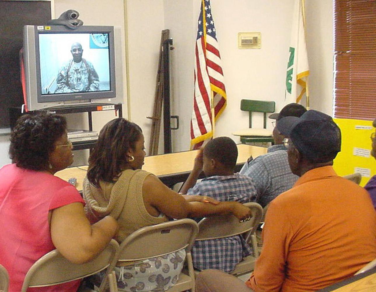 The Pittman family participates in a Freedom Call, which connects soldiers serving in Iraq to their families back home through videoconferencing technology.