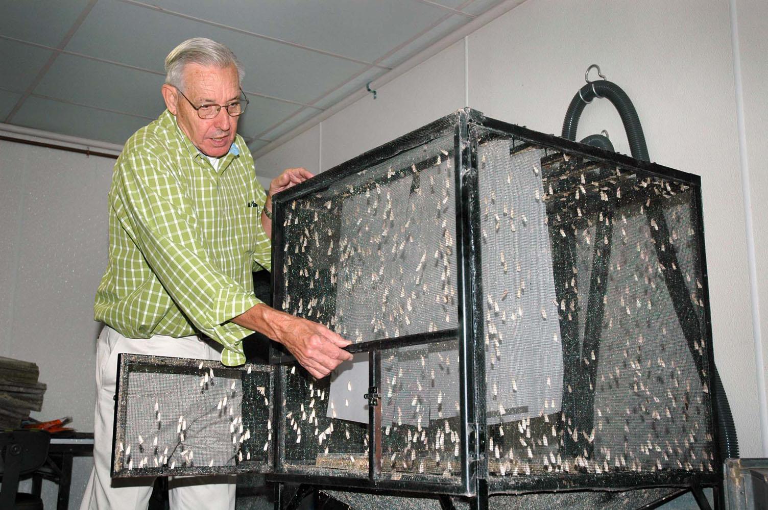 Frank Davis displays one of the large cages developed for holding adult southwestern corn borer moths at the U.S. Department of Agriculture's Agricultural Research Service facility in Starkville. (Photo by Linda Breazeale)