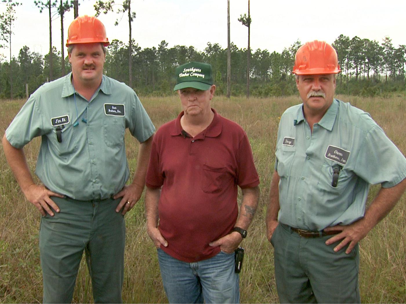 Jim Ed Owen, left, and Terry Owen, far right, of Wiggins, learned the craft of logging and the importance of stewardship from their father, Walt. The brothers have operated their own business for more than 11 years. (Photo bb Leighton Spann)