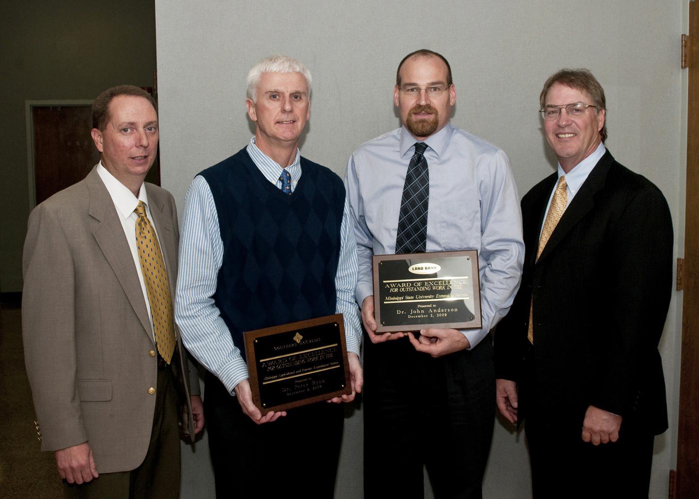 Two Mississippi State University agricultural division employees were recently honored for service and career achievement. From left are award sponsor representative Michael Barnes of Southern Ag Credit; Peter Ryan, recipient of the 2009 MAFES Excellence in Research Award; John Anderson, recipient of the 2009 Outstanding Extension Worker Award; and award sponsor representative Bill Cook of the Land Bank of North Mississippi. (Photo by Scott Corey)