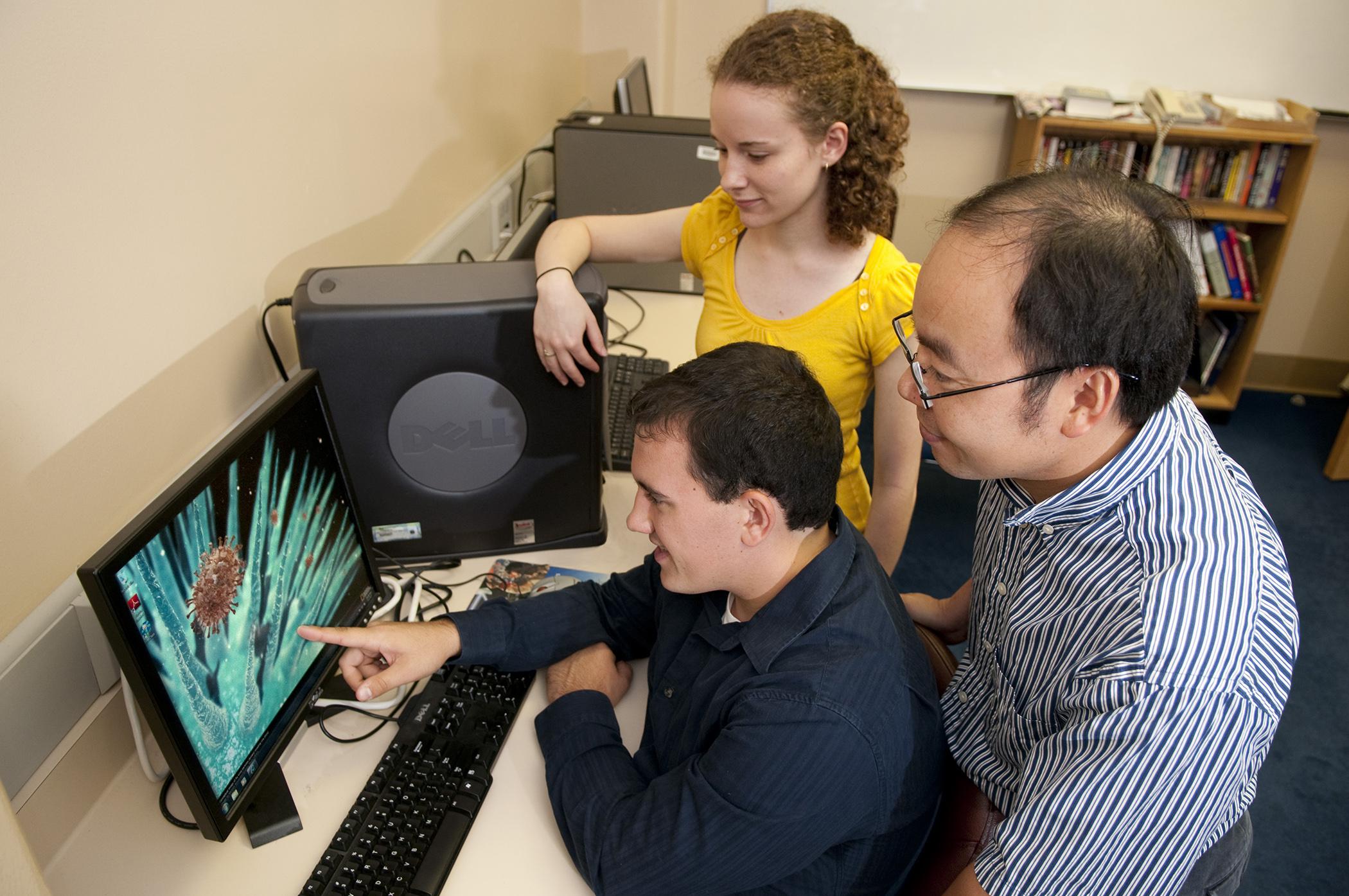 Dr. Henry Wan (far right), an associate professor at Mississippi State University's College of Veterinary Medicine, works with two of his students on his Antigen program in support of influenza vaccine research. (Photo by MSU College of Veterinary Medicine/Tom Thompson).