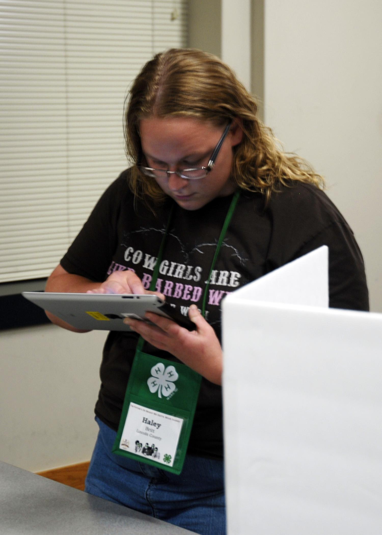 Haley Britt of Lincoln County uses an iPad instead of a paper ballot on May 28, 2014 to vote for State 4-H Council officers during the annual 4-H Club Congress at Mississippi State University. (Photo by MSU Ag Communications/Libby Durst)