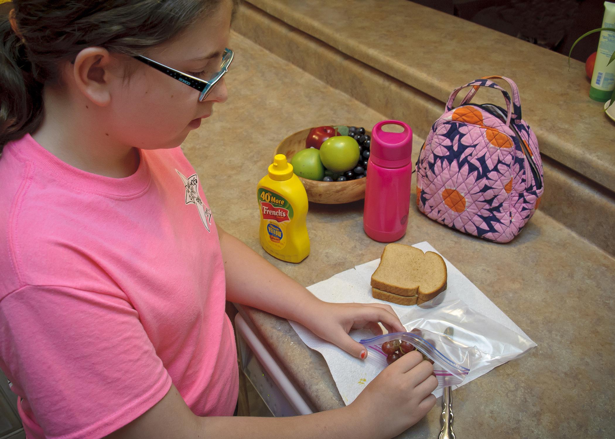 When packing lunches, children and adults need to follow good hygiene and food safety practices, such as starting with clean hands, a clean work surface and a clean lunch box. (Photo by MSU Ag Communications/Kevin Hudson)