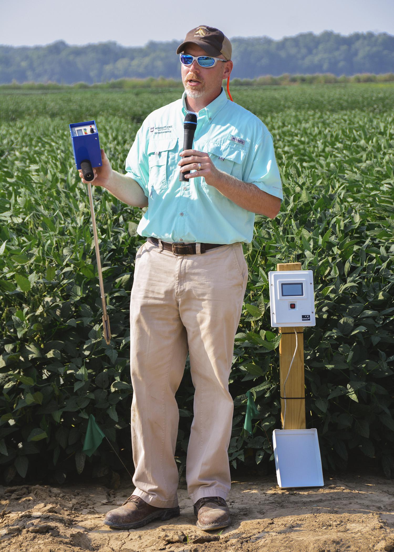 Jason Krutz, an irrigation specialist at the MSU Delta Research and Extension Center, reviews different types of moisture meters available to help farmers determine irrigation timing. Krutz took part in the North Mississippi Research and Extension Center's Agronomic Row Crops Field Day in Verona, Mississippi, on Aug. 7, 2014. (Photo by MSU Ag Communications/Linda Breazeale)