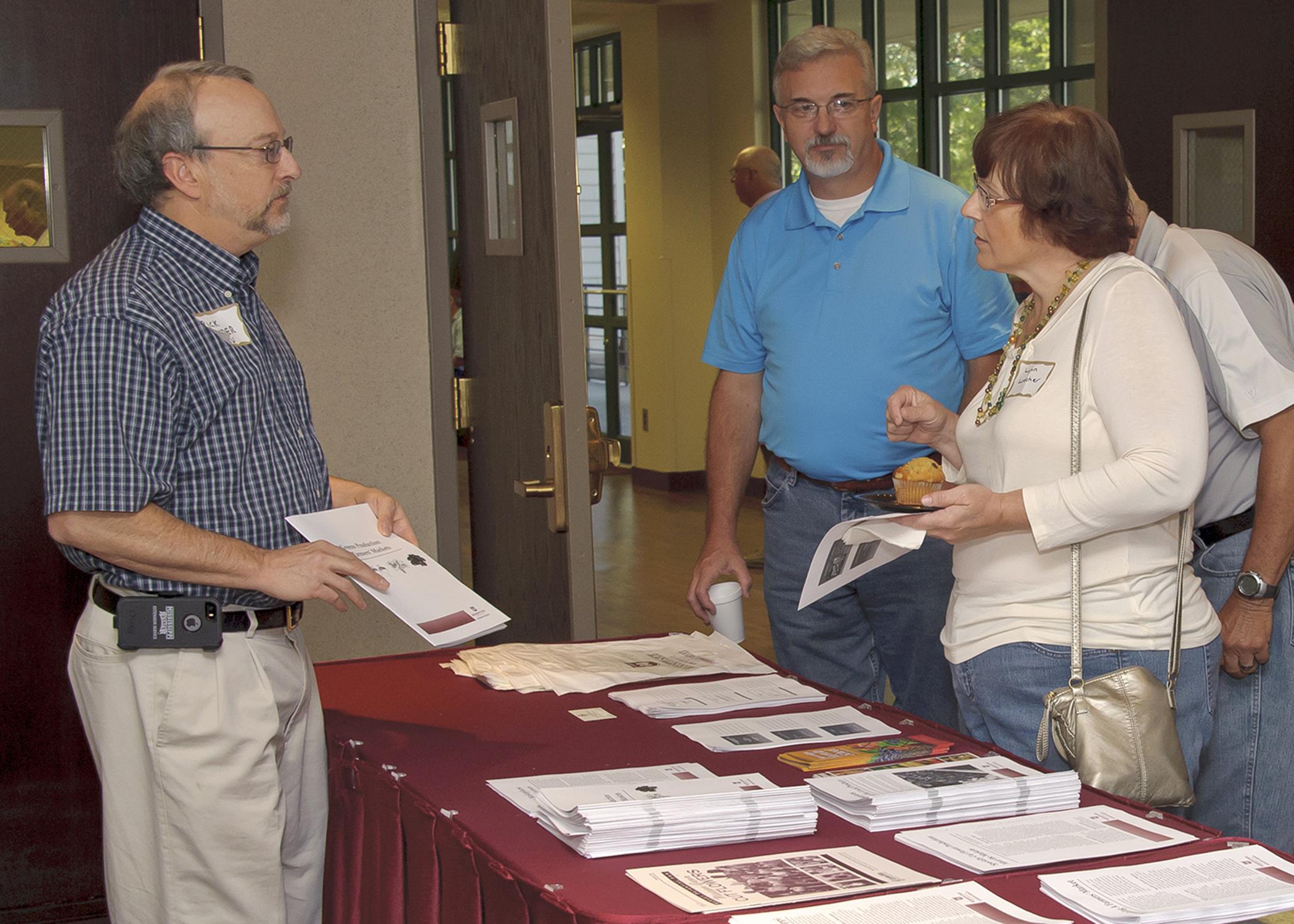 Rick Snyder, Mississippi State University horticulture expert, talks to Joseph Wilson, center, and Lynn Loecher at the microfarming workshop in Raymond on Aug. 28, 2014. The two-day event helped growers understand the benefits and facts of growing for and selling at farmers markets. (Photo by MSU Ag Communications/Kevin Hudson)