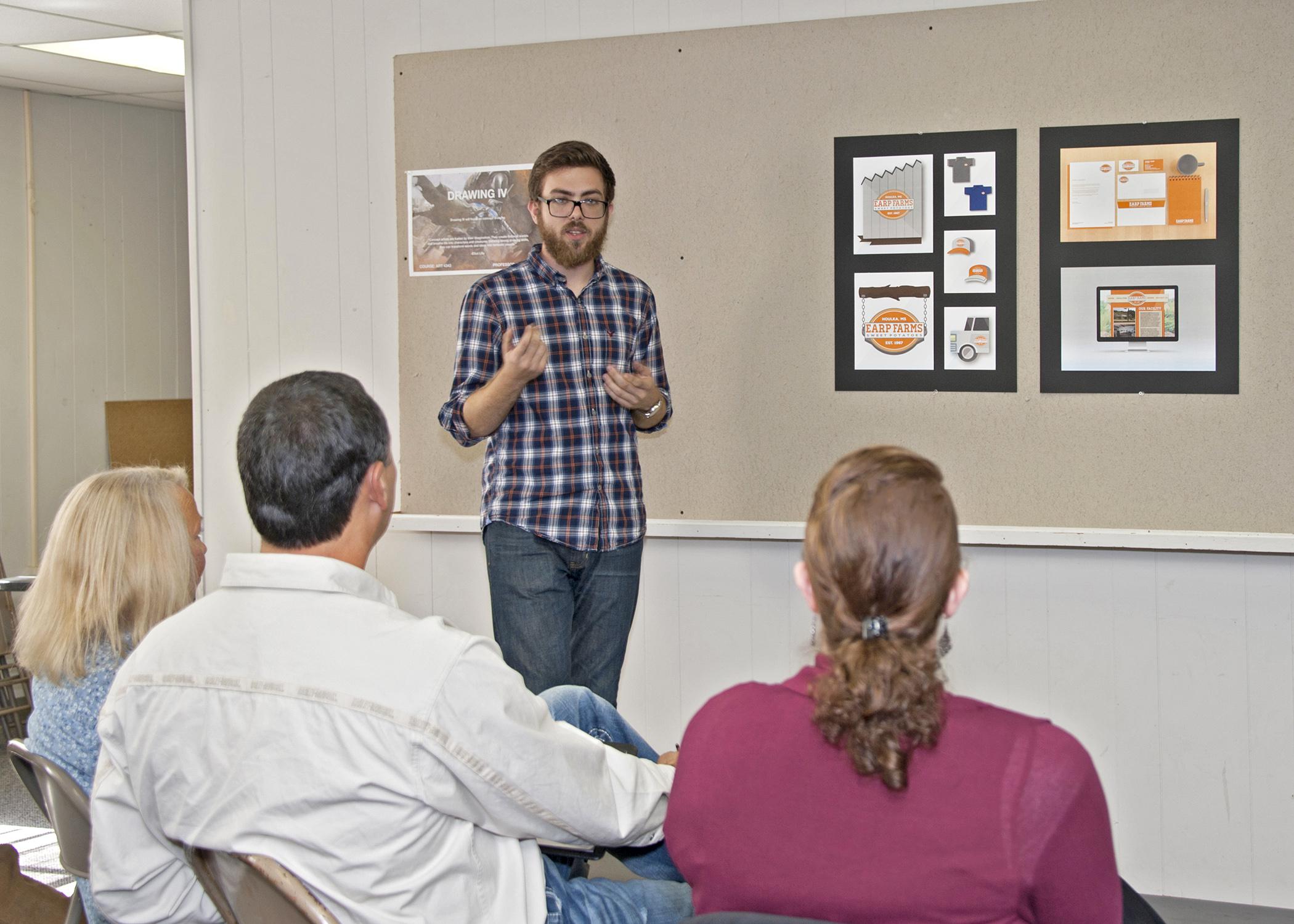 On Nov. 6, 2014, Austin Edwards, a Mississippi State University senior graphic design major from Gulfport, explains his concept in class for a new brand image for Earp Farms in Houlka. (Photo by MSU Ag Communications/Kat Lawrence)