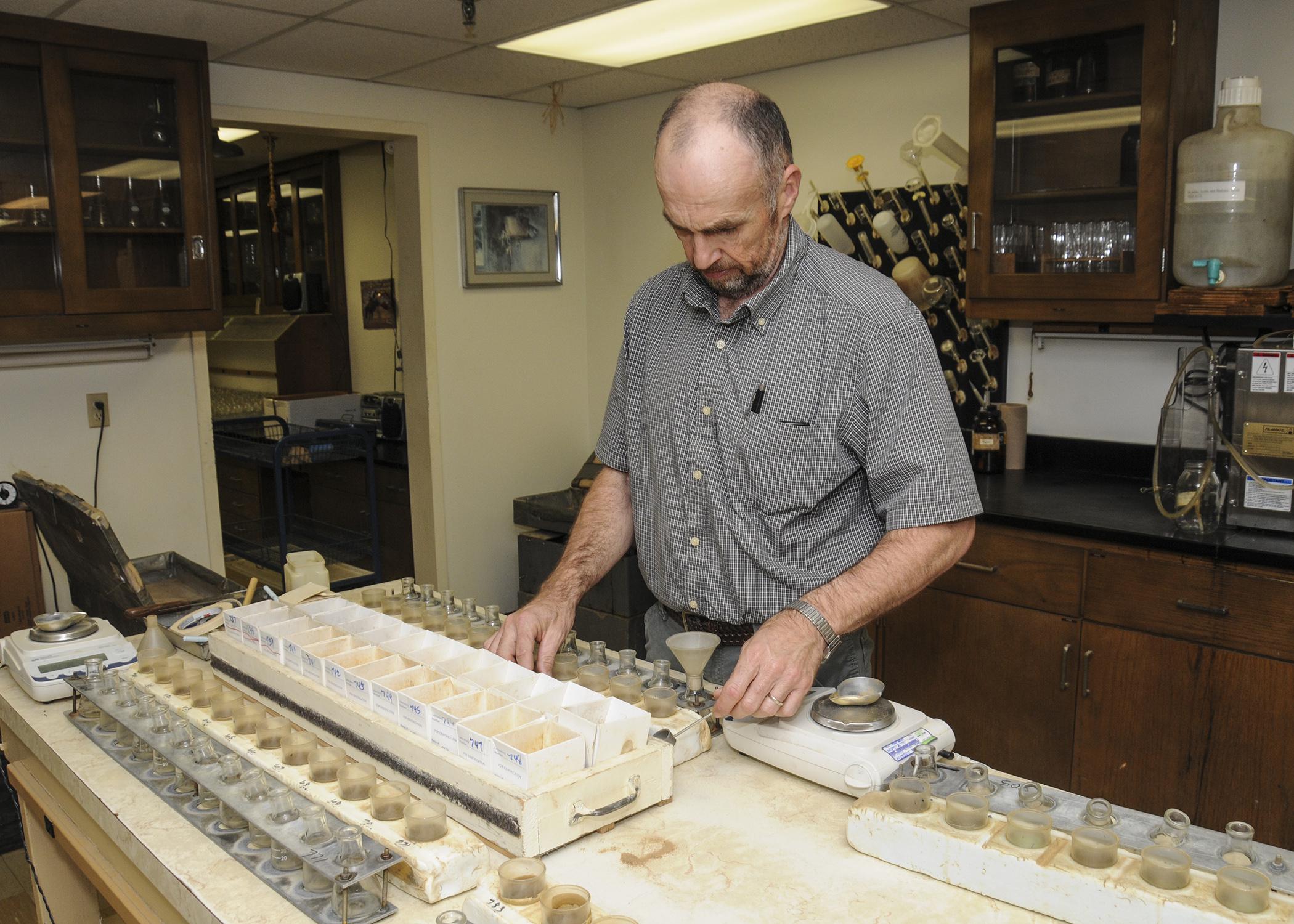 Mississippi State University Extension Service agronomy specialist Keith Crouse sorts through routine samples on April 10, 2013, in the MSU Soil Testing and Plant Analysis Lab, where every day is Earth Day, not just April 22. (Photo by MSU Ag Communications/Scott Corey)
