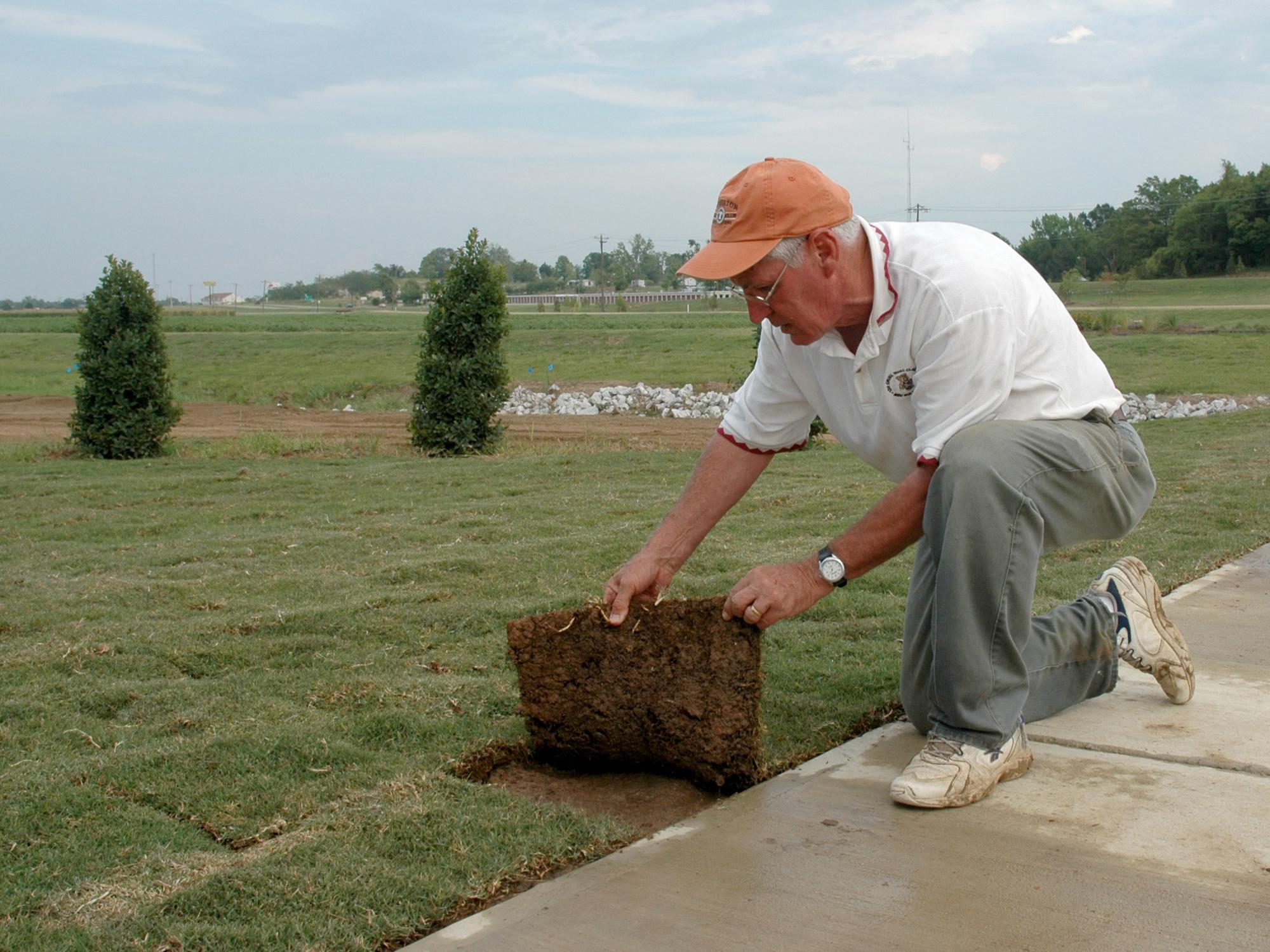 Mississippi State University Extension turf specialist Wayne Wells inspects newly laid sod during the establishment of the Veterans Memorial Rose Garden, near the entrance to the R. Rodney Foil Plant Science Research Facility. (File photo by MSU Ag Communications/Linda Breazeale)