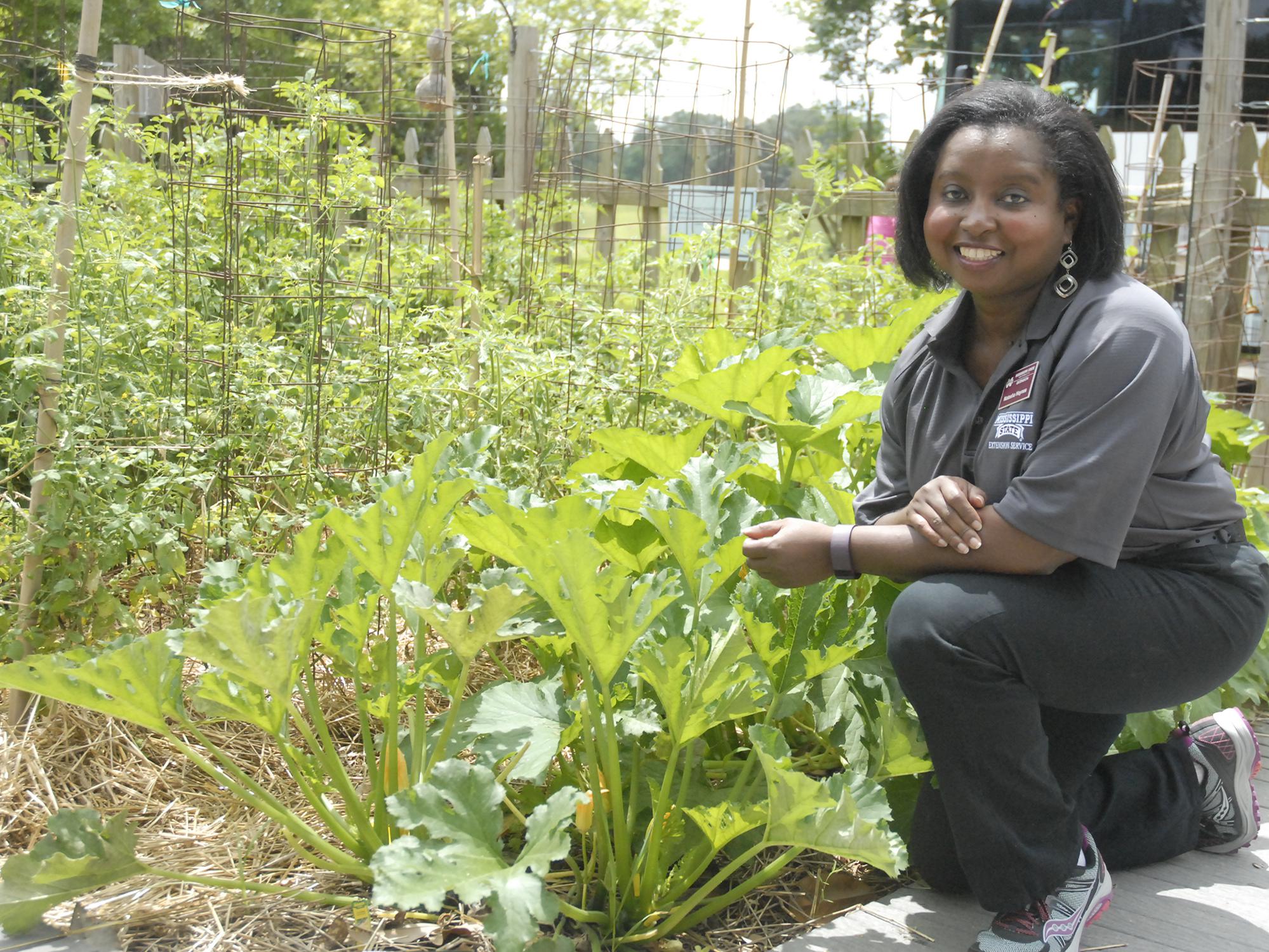 Natasha Haynes, Mississippi State University Extension agent in Rankin County, advocates choosing one local ingredient to spotlight in a menu, such as this squash growing at the Southern Heritage Garden at the Vicksburg National Military Park on June 13, 2017. (Photo by MSU Extension Service/Bonnie Coblentz)