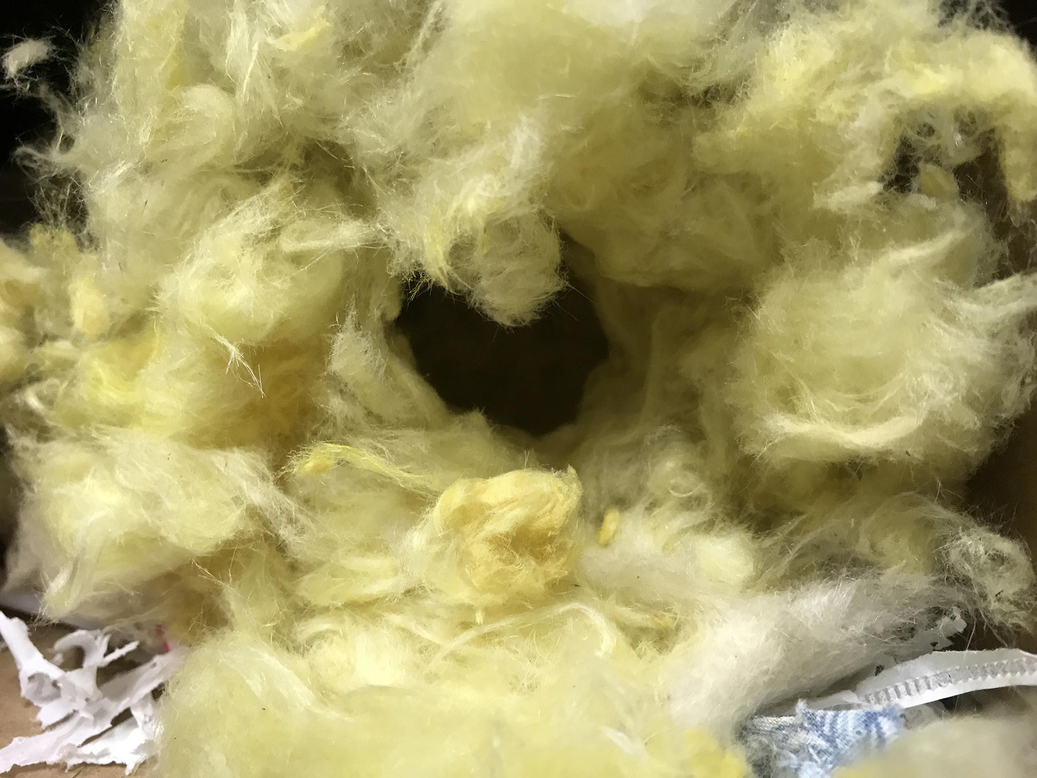 a nest built by mice using insulation and a variety of other materials