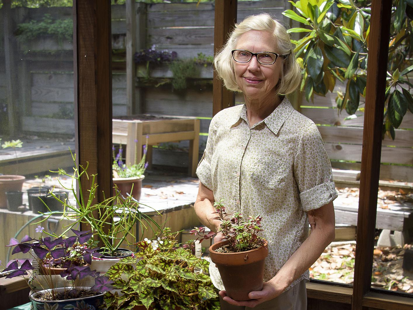 Lida McDowell holds an alternanthera plant at her home in Hattiesburg, Mississippi, on April 27, 2017. McDowell is a member of the Pine Belt Master Gardeners -- one of more than 60 such groups throughout the state that operate under the supervision of the Mississippi State University Extension Service. (Photo by MSU Extension Service/Kevin Hudson)