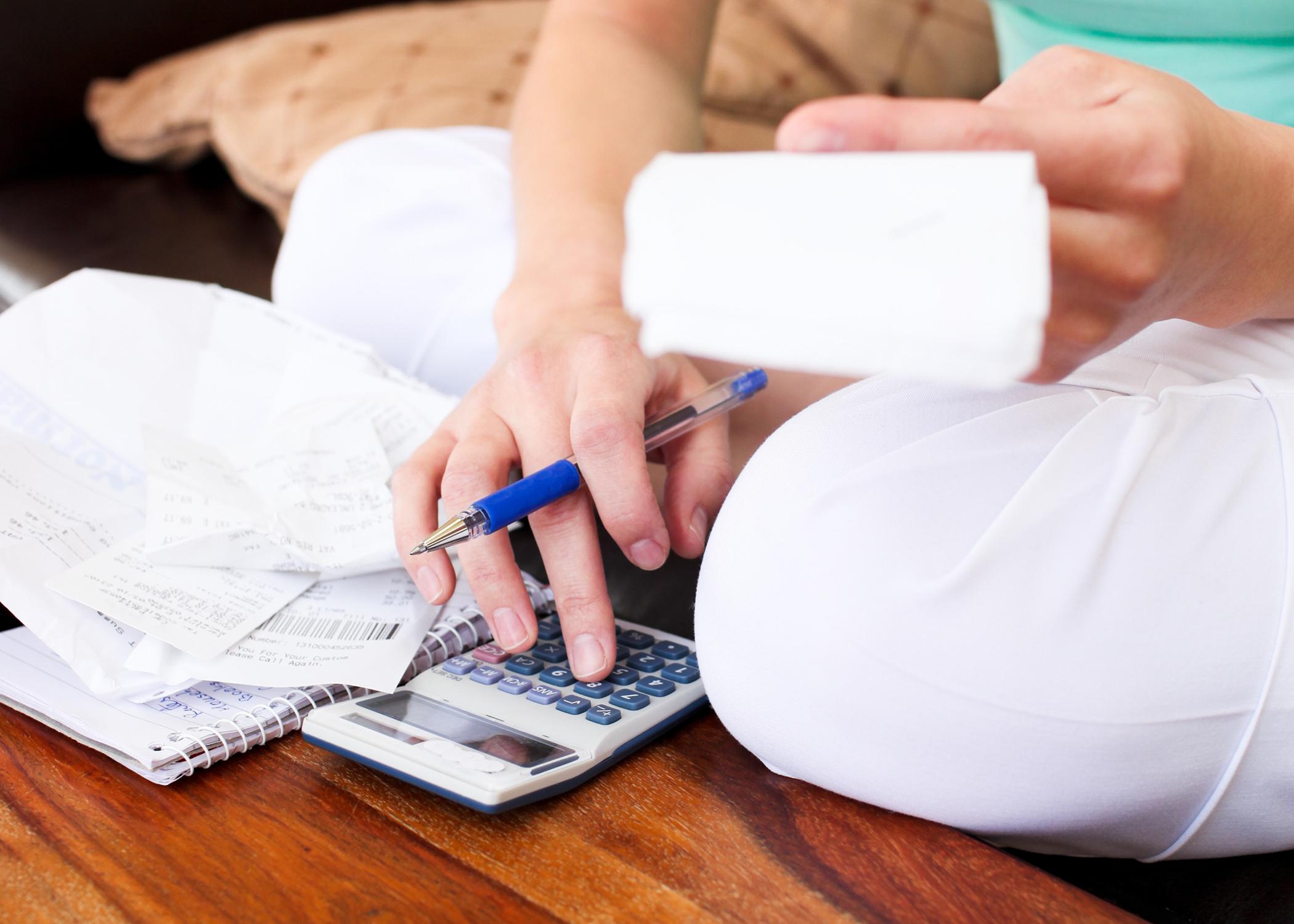 Closeup of a woman budgeting personal finances.