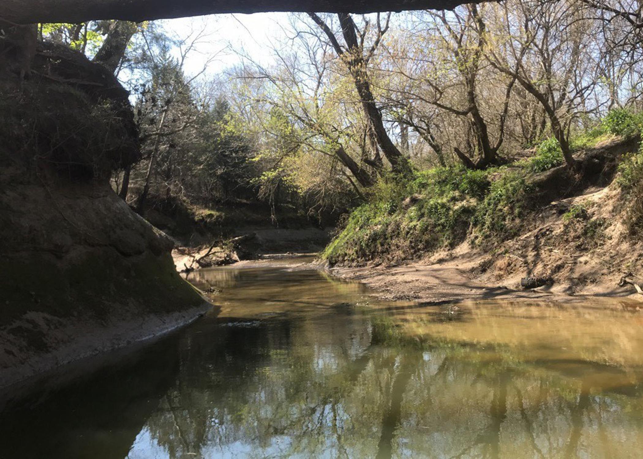 A shallow creek between two hills.