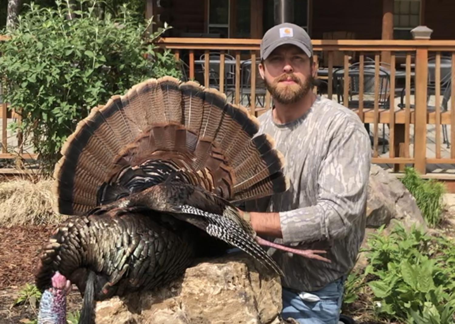 A hunter shows off a turkey he harvested.