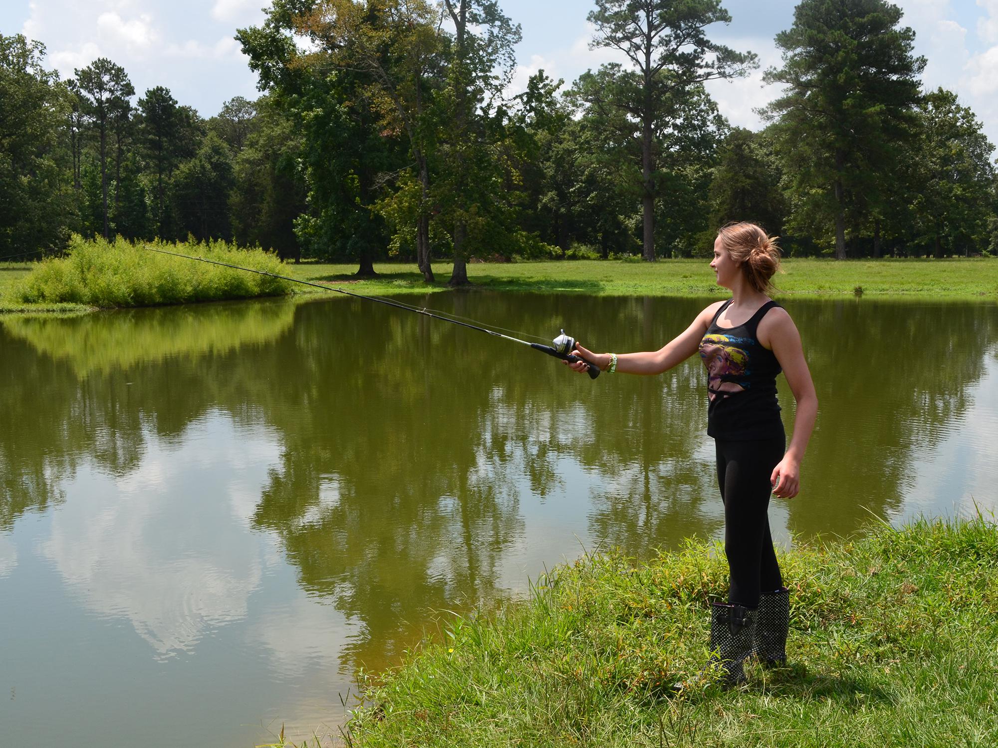 This young angler is actually helping an Oktibbeha County pond grow larger fish. Pond and lake managers need to harvest 1 pound of bass to 5 pounds of bream, usually beginning in the third year after stocking, to promote larger fish. (MSU Extension Service file photo/Linda Breazeale)