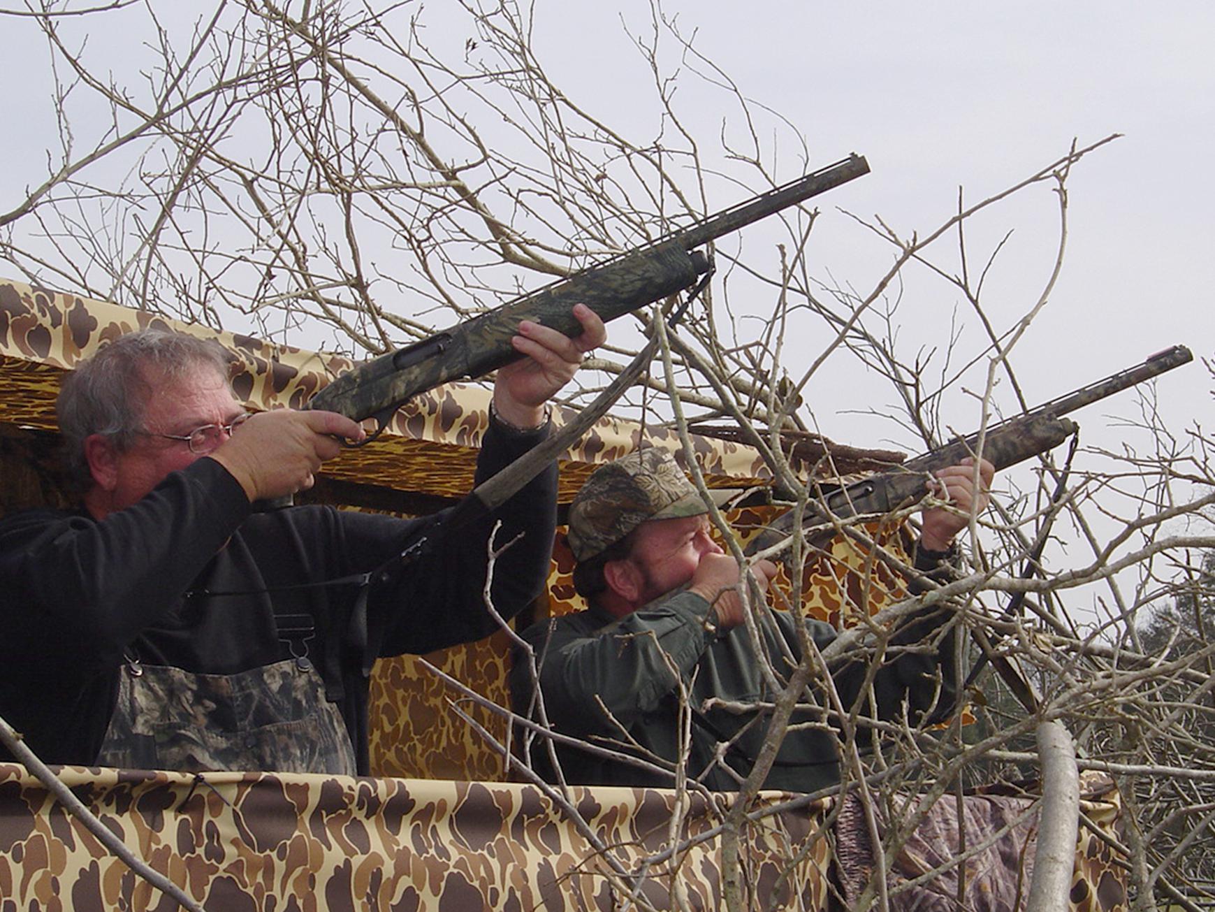 Two hunters in Claiborne County take aim at incoming crows. Much like duck hunting, participants wait in blinds overlooking decoys. (File photo by MSU Extension Service/Cliff Covington)