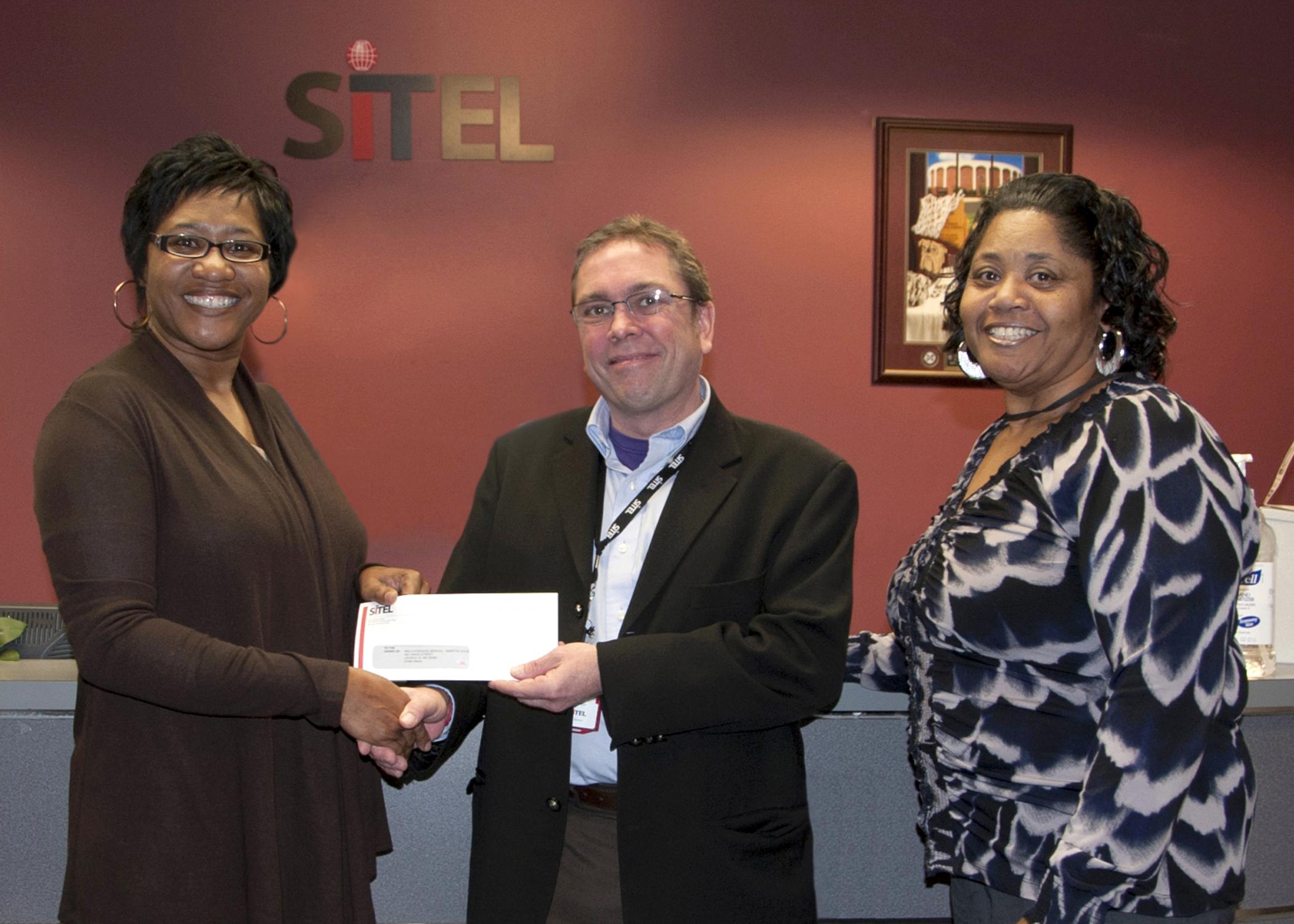 Sandra Jackson, left, a Mississippi State University Extension Service program associate, accepts a check from Dave Billington, Sitel Starkville site director, on behalf of Sitel’s employee recognition program. Stella Jackson, right, Sitel’s 2012 International Customer Management Institute Supervisor of the Year, chose to support the Winston County 4-H Youth Development program through Sitel’s recognition program because of the positive impact it has on local youth. (Photo by MSU Ag Communications/Kat Lawre