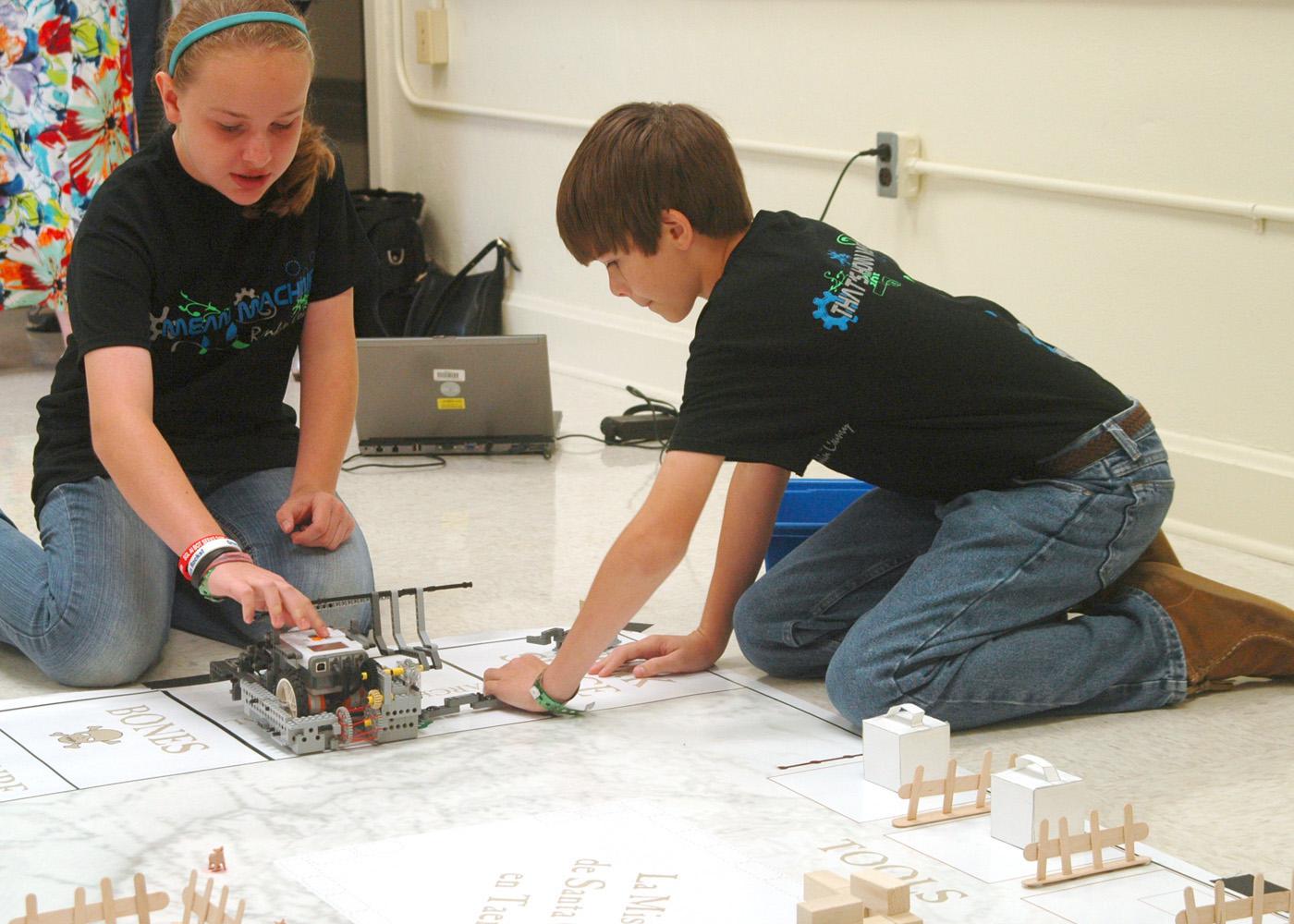 Lillian Stewart and Thaddeus Webb, members of The Mean Machines 4-H robotics team in Rankin County, practice with their robot before afternoon competition at the Southwest District 4-H Project Achievement Day held at Hinds Community College in Raymond, Mississippi. Junior 4-H members, ages 8 to 13, participated in contests on a variety of topics, including foods and nutrition, engineering, and meat and dairy judging on June 6, 7, 12 and 13. (Photo by MSU Ag Communications/Susan Collins-Smith)