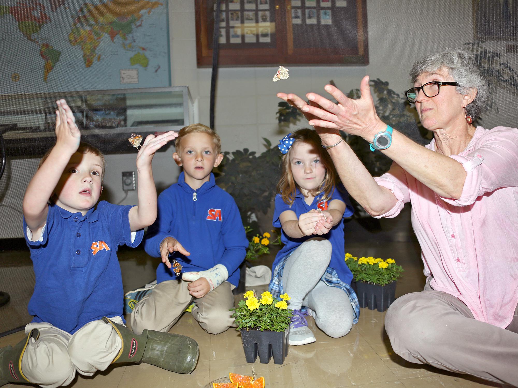 From left, kindergarteners Garrison Baker, Knox Smith and Piper Graves learn about painted lady butterflies with Lois Connington, keeper of the Insect Zoo at Mississippi State University’s Clay Lyle Entomology Building on Thursday, April 14, 2016 in Starkville, Miss. (Photo by MSU Extension Service/Kat Lawrence)