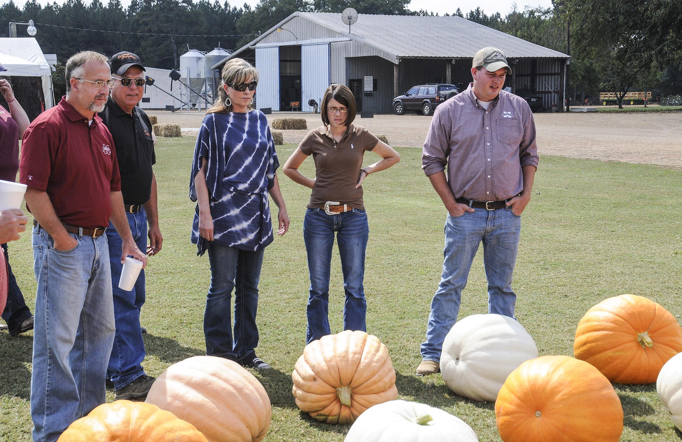 Extension agricultural agents review pumpkins recently harvested at County Pumpkins in Lowndes County. The fall tour participants include, from left, Jeff Wilson of Lowndes County, farm owner Dwight Colson of Caledonia, Kimberly Wilborn of Lamar County, Julie White of Oktibbeha County and Reid Nevins of Lowndes County. (Photo by MSU Ag Communications/Scott Corey)