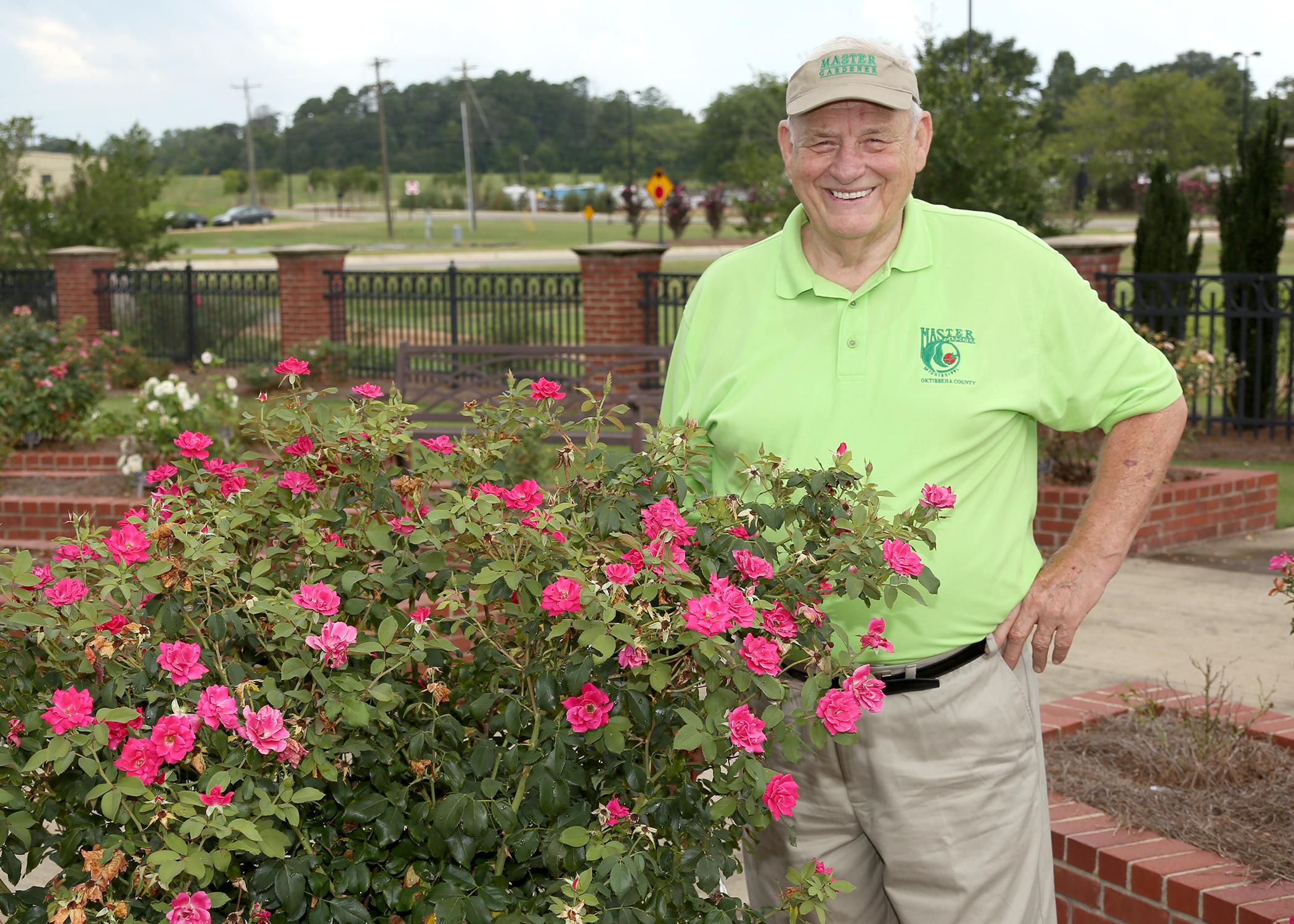 Oktibbeha County Master Gardener Charlie Weatherly pauses July 23, 2015, beside some of flowers growing in the Veterans Memorial Rose Garden, which he helped establish at the R.R. Foil Plant Science Research Center at Mississippi State University. (Photo by MSU Ag Communications/Kat Lawrence)