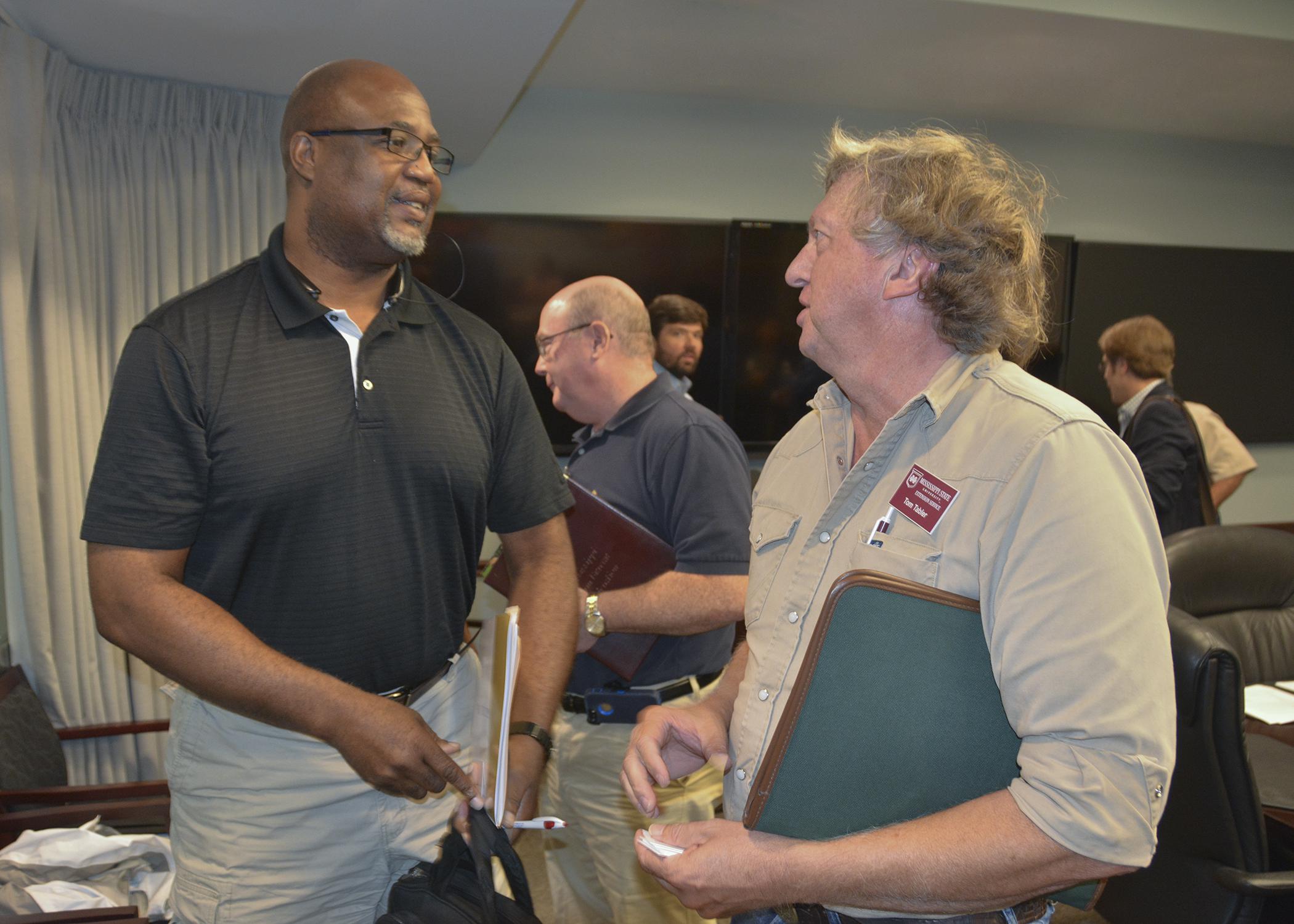 Greg Walker, director of human resources for Mar-Jac Poultry, left, talks to Tom Tabler, a poultry specialist with the Mississippi State University Extension Service, during a bird flu information meeting at the Mississippi Emergency Management Agency office in Pearl on Sept. 11, 2015. (Photo by MSU Ag Communications/Linda Breazeale)