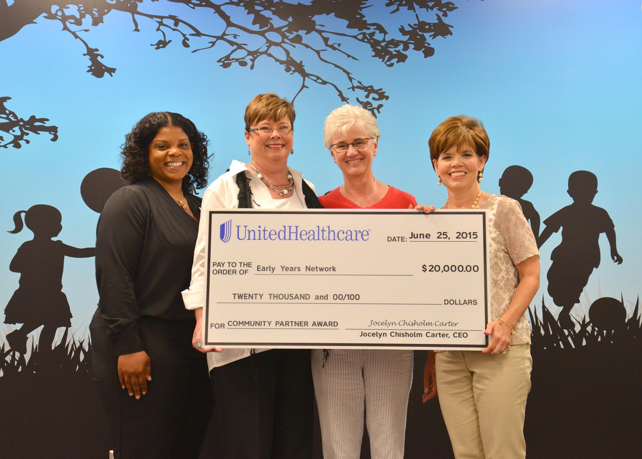 Representatives of the Early Years Network and UnitedHealthcare take part in a check presentation ceremony during the grand opening of the Hinds County Resource and Referral Center at 350 West Woodrow Wilson Avenue in Jackson, Mississippi on June 25, 2015. Celebrating their newly formed partnership are Kenisha Potter, left, pediatric health care coordinator for UnitedHealthcare; Louise E. Davis, professor with the Mississippi State University Extension Service and director of the Early Years Network; Connie