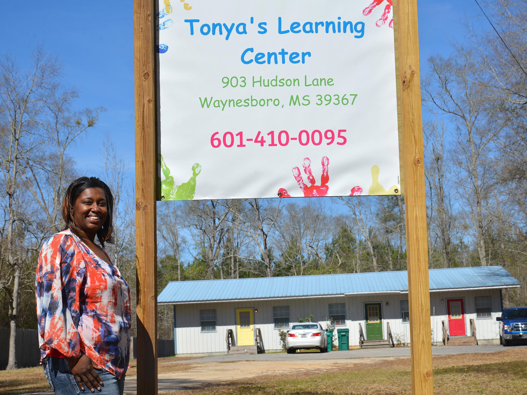 LaTonya Hill stands outside Tonya’s Learning Center, her new licensed child care center in Waynesboro, Mississippi on Feb. 18, 2016.