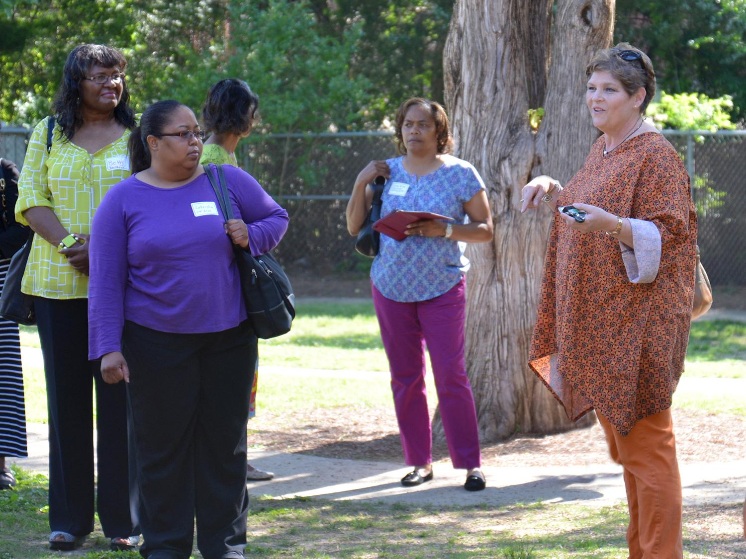 The Mississippi State University Aiken Village Preschool director Lucy Bryant, on right, led a tour of the facility and playground for a group of early care and education providers interested in quality improvements. (Submitted photo)