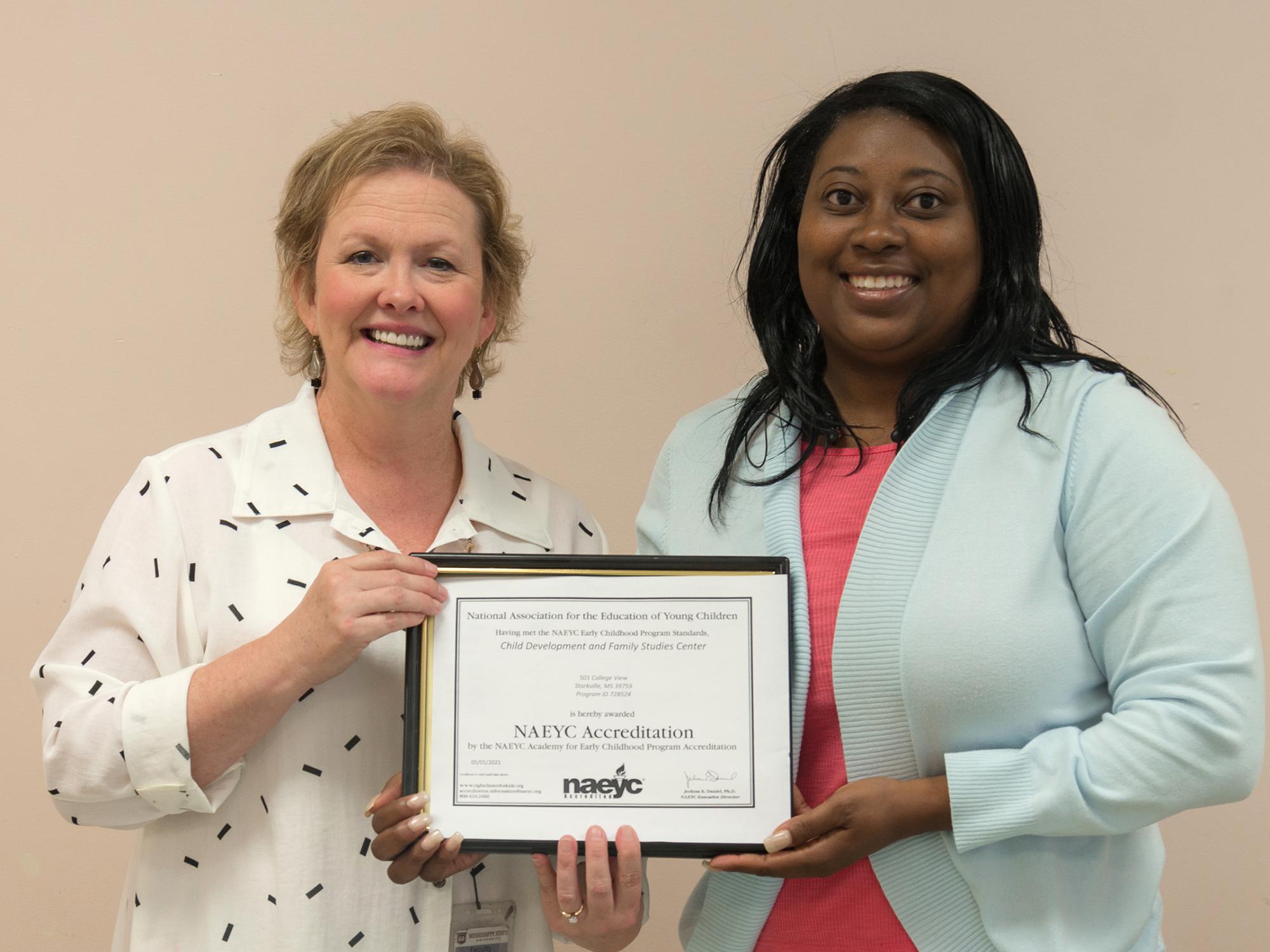 Melissa Tenhet, director of the Mississippi State University School of Human Sciences’ Child Development and Family Studies Center, left, and Andrelyn Smith, center manager, celebrate the center’s recent notice of accreditation. (Photo by MSU Extension Service/David Doleac)