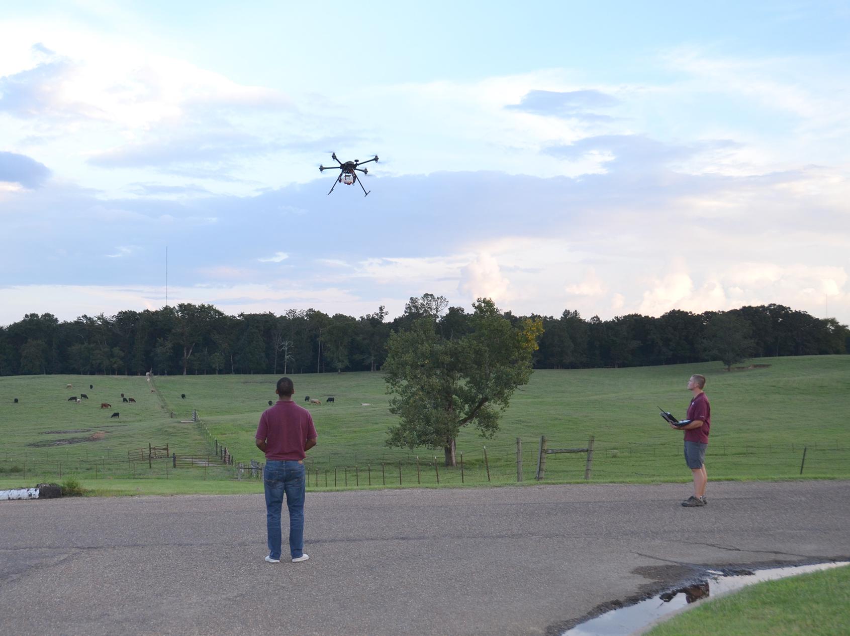 David Young, left, and Sean Meacham, both with the Mississippi State University Geosystems Research Institute, demonstrate one model of unmanned aircraft in Raymond on Aug. 29 for members of Mississippi’s U.S. congressional staff during a two-day tour of the state’s agricultural industry. (Photo by MSU Extension Service/Susan Collins-Smith)