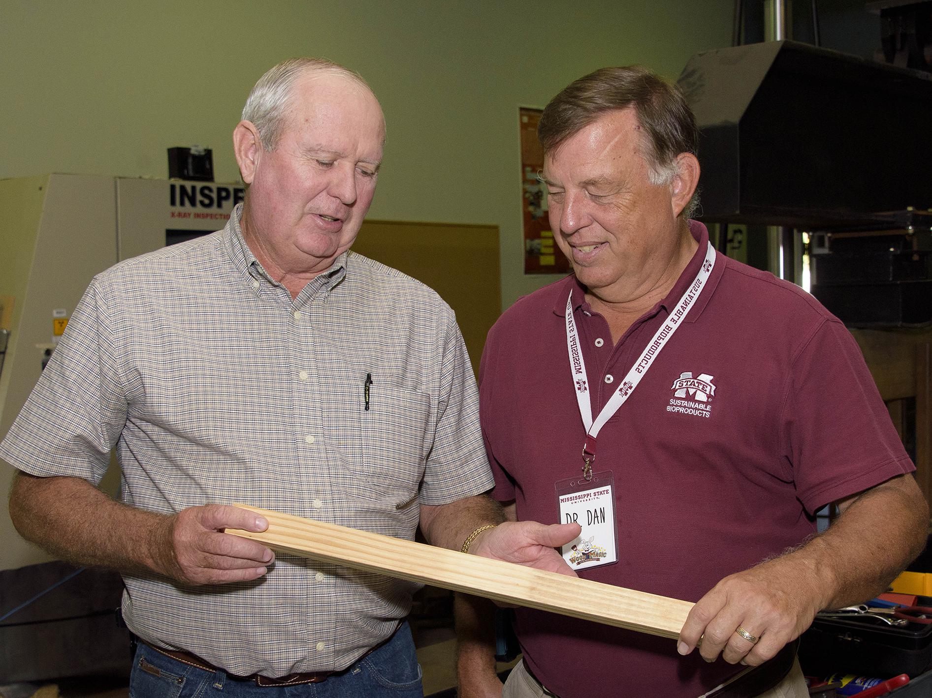 Mississippi Representative Ken Morgan of Marion County, left, examines a wood product held by Dan Seale, a professor of sustainable bioproducts at the R.T. Clapp Forest Products Lab at Mississippi State University. Morgan and other members of Senate and House agricultural committees visited MSU on Oct. 18 and 19, 2016. (Photo by MSU Extension Service/Kevin Hudson)