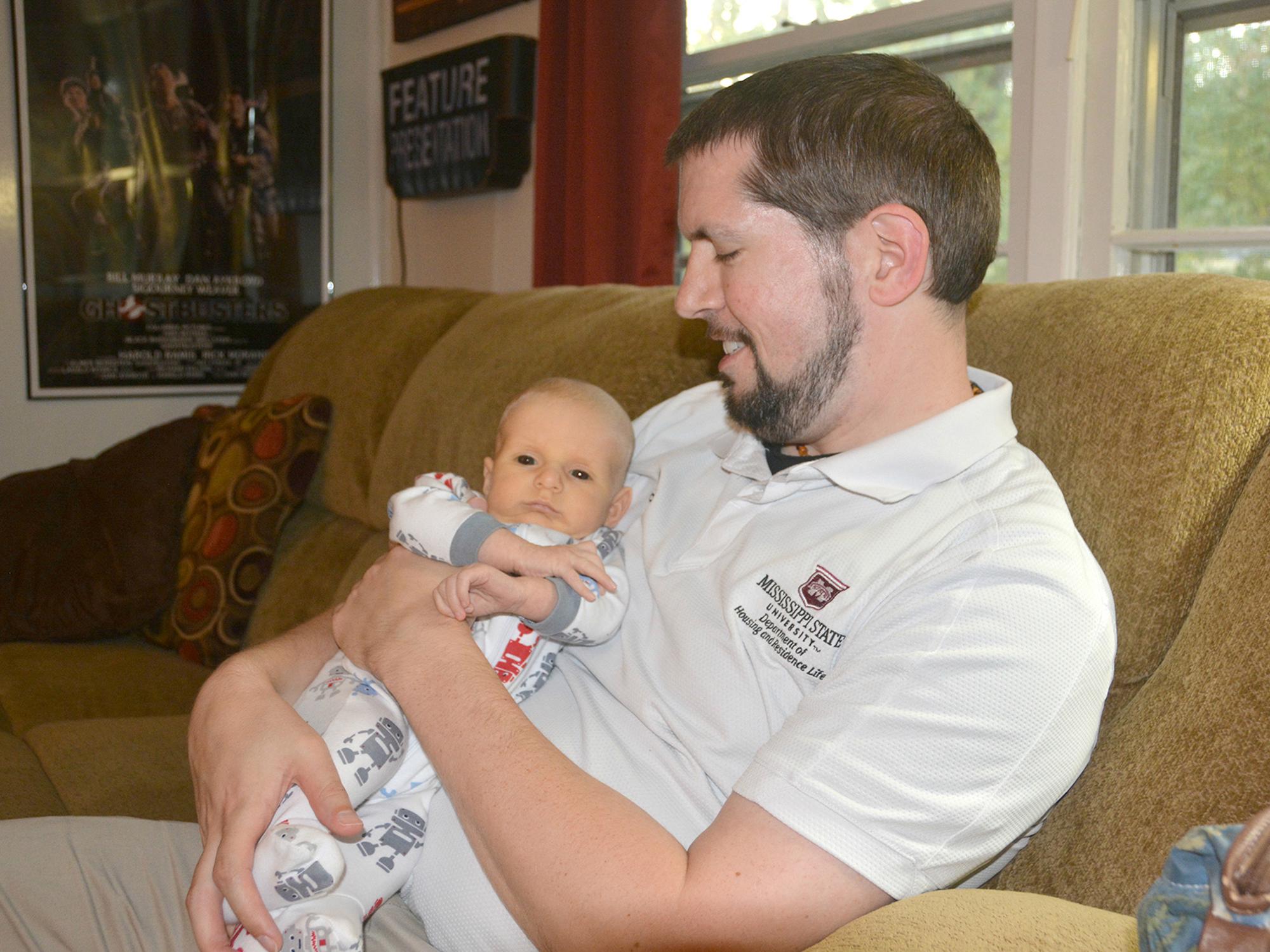 Boone Purser enjoys afternoon cuddles with his son, Benji, on Oct. 31, 2016. Benji is a breastfed baby who thrives on attention from both his parents at his home in Starkville, Mississippi. (Photo by MSU Extension Service/Linda Breazeale)