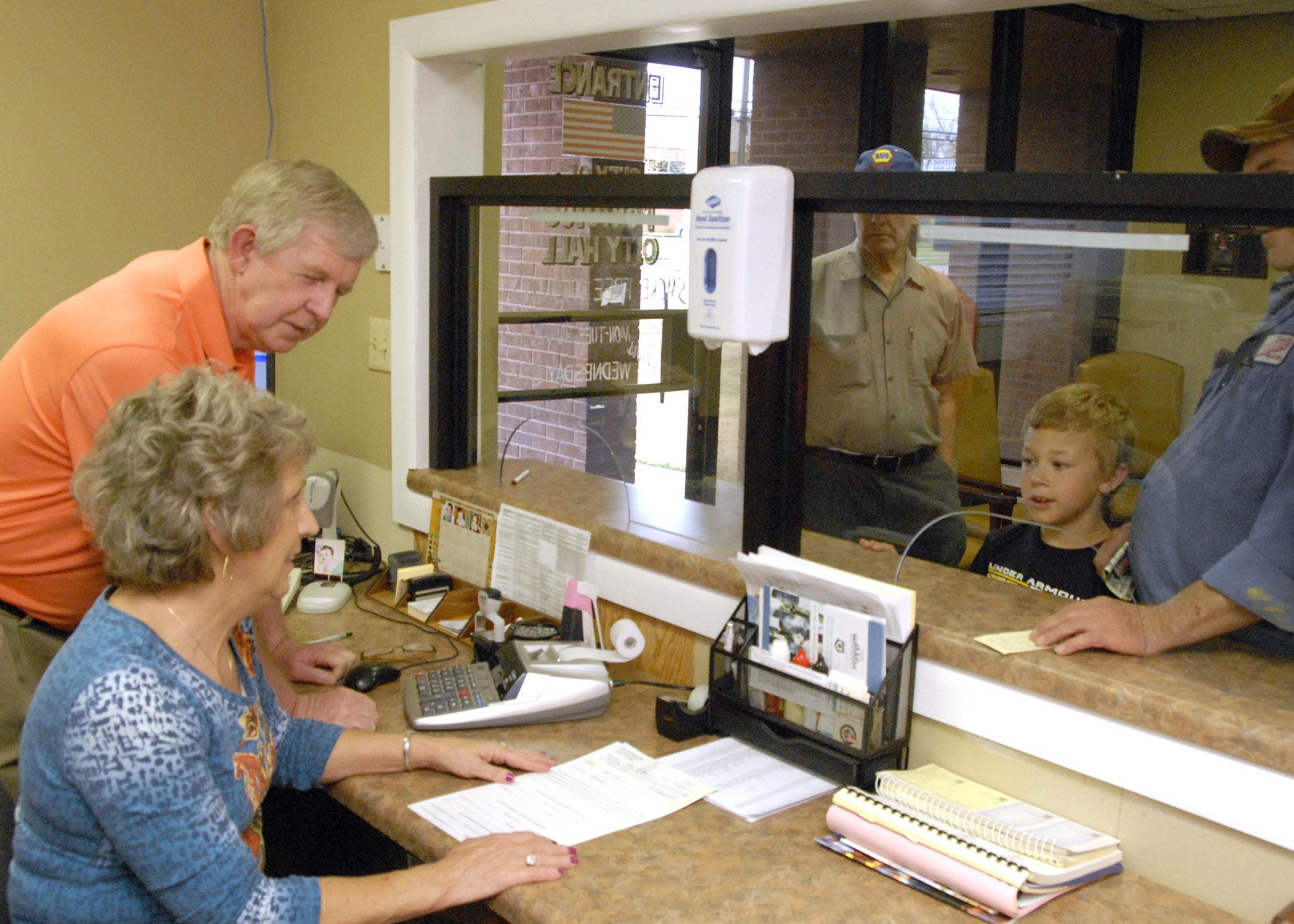 Pontotoc city clerk Dexter Warren and deputy clerk Jamie Sappington assist city residents with utility payments and other city business. The week of May 5 - 11 has been designated Municipal Clerks Week to recognize the service of clerks and their deputies to communities. (Photo by MSU Extension Service Center for Government and Community Development/Bob Ratliff)