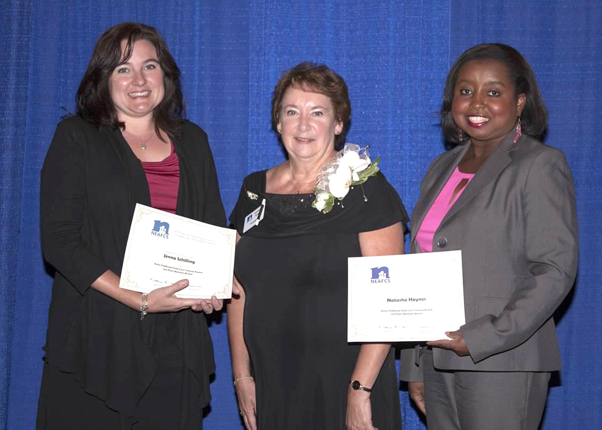 National Extension Association for Family and Consumer Sciences past president Kathleen Ann Olson, center, presents Jenna Schilling, left, and Natasha Haynes with the Early Childhood Child Care Training Award for the TummySafe program at the NEAFCS Annual Conference in Lexington, Kentucky on Sept. 18, 2014. (Submitted Photo)