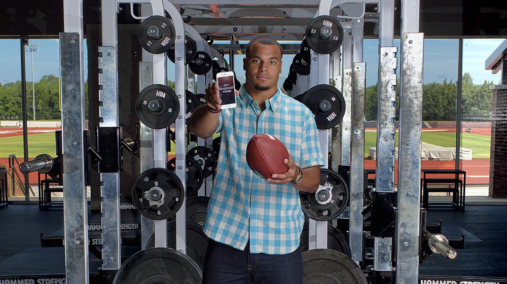 DAK holding football and phone during Colon Cancer Screening PSA shoot.