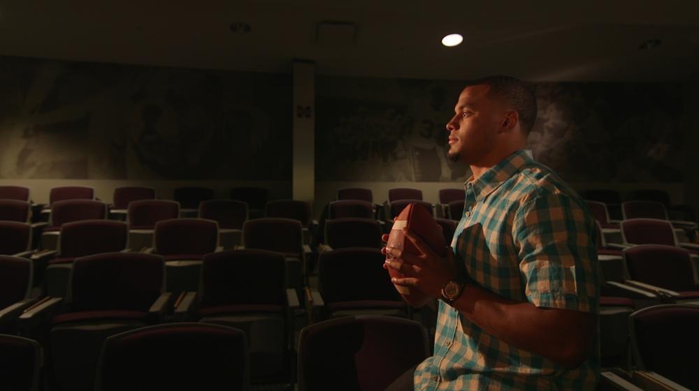 Dak holding a football during the Colon Cancer Screening PSA shoot.