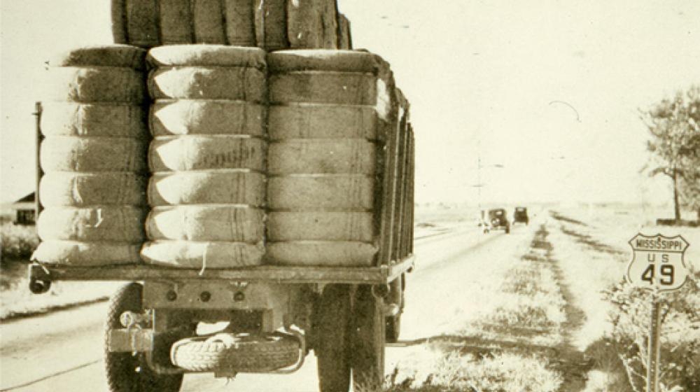 Archival image of truck with cotton bales.